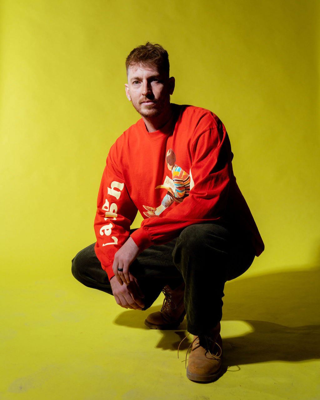 andrew scites posing on long sleeve laugh daily apparel shirt