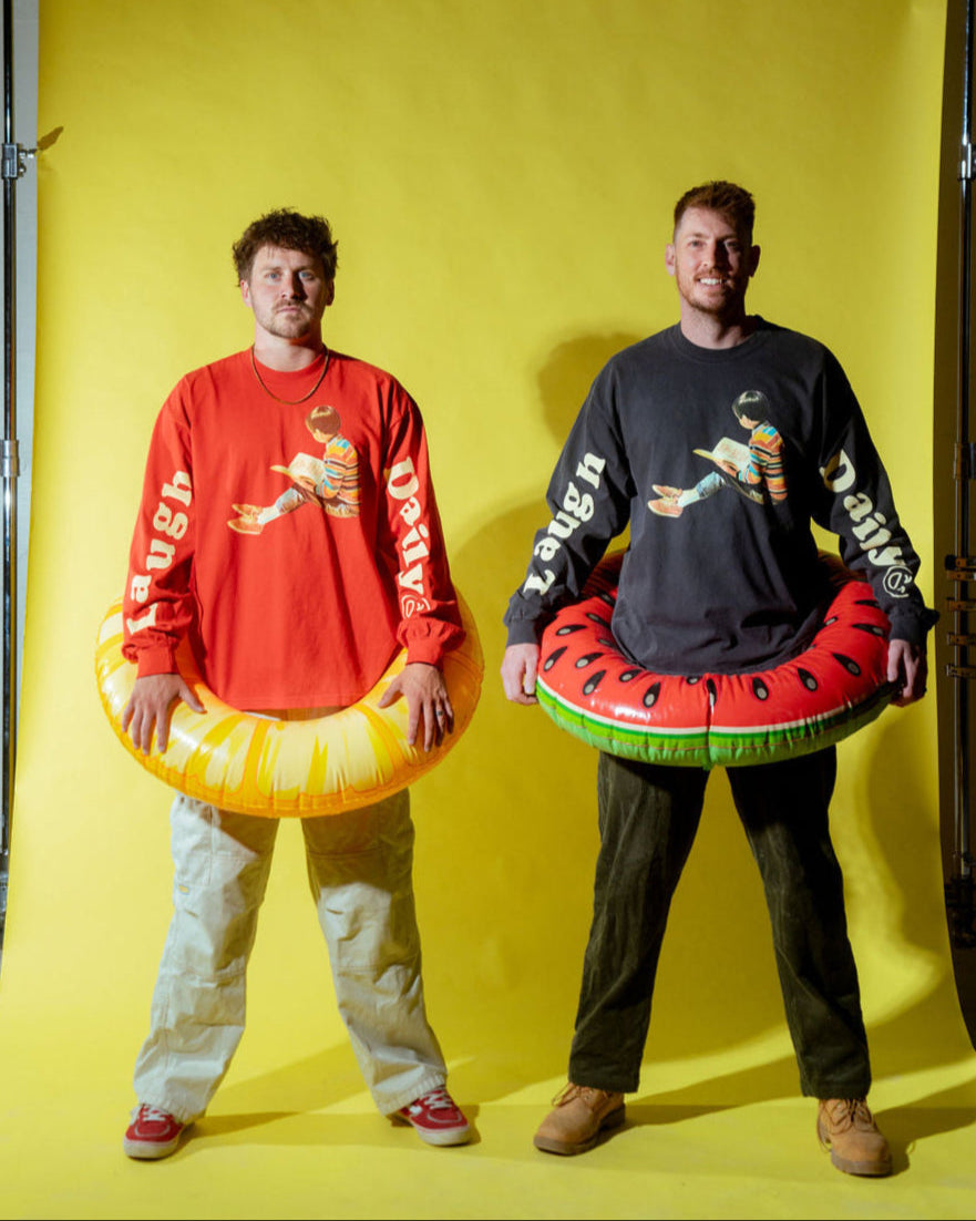 justin stuart and andrew scites standing together with beach floaties around their waists wearing laugh daily apparel long sleeve shirts