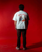 laugh daily tee back of model wearing shirt standing with red back drop